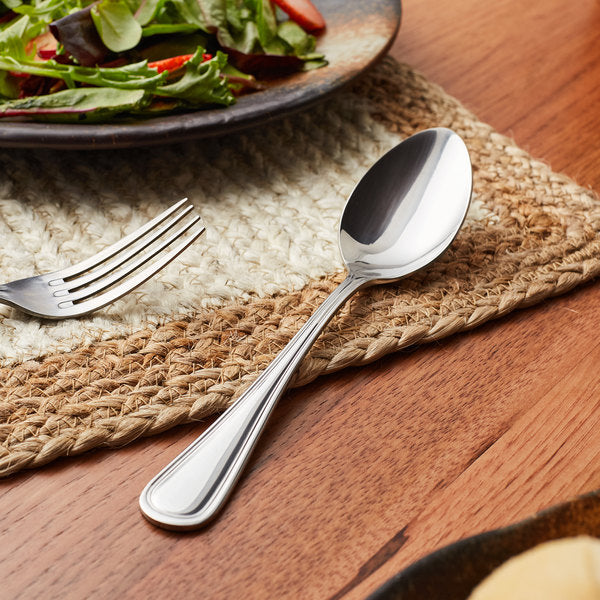 a set of silverware by a salad